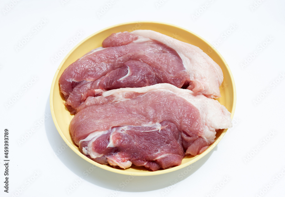 Pork meat in yellow plate on white background.
