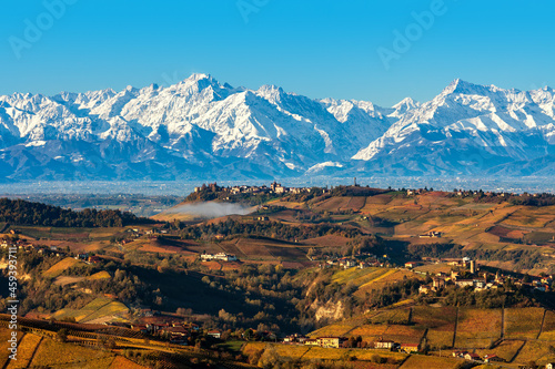 View of autumnal hills and snowy mountains in Italy. photo