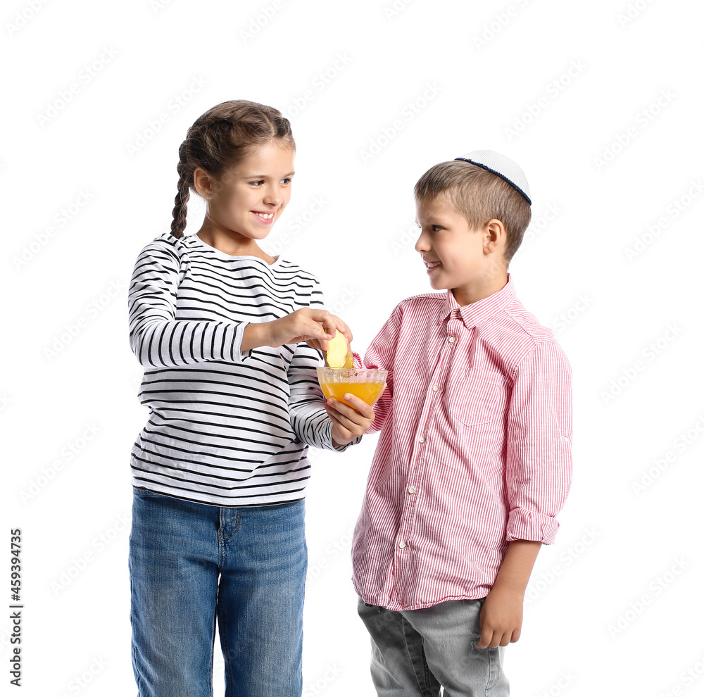 Little children with honey and apple on white background. Rosh Hashanah (Jewish New Year) celebration Little children with honey and apple on white background. Rosh Hashanah (Jewish New Year) celebration