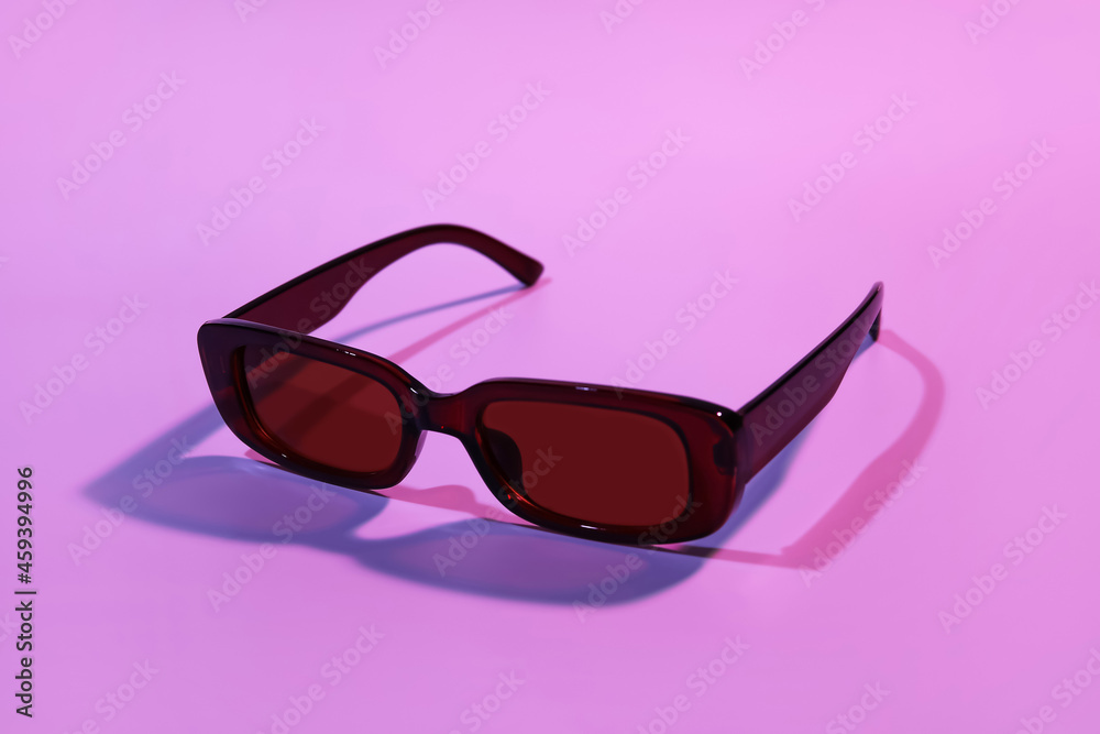 Stylish female sunglasses on color background Stylish female sunglasses on color background