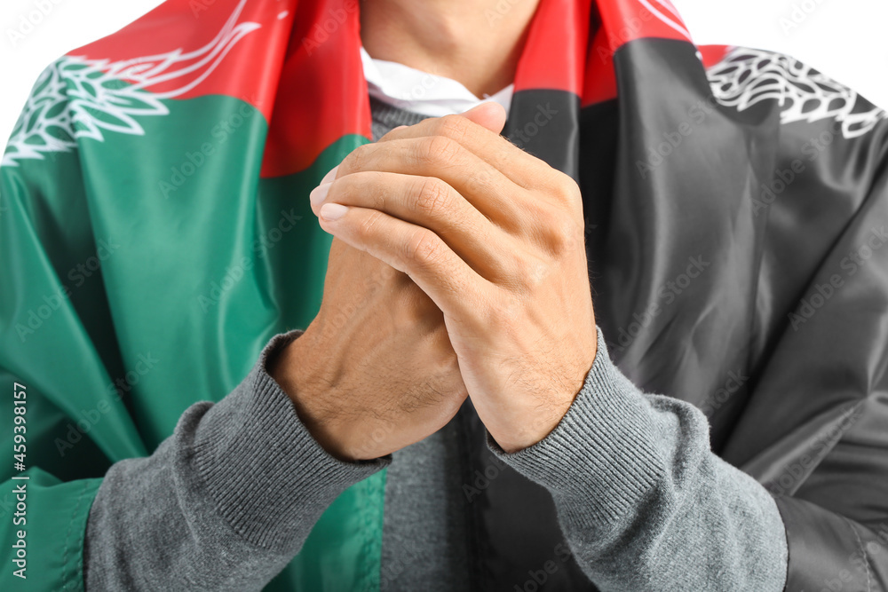 Praying Muslim man with flag of Afghanistan on white background, closeup