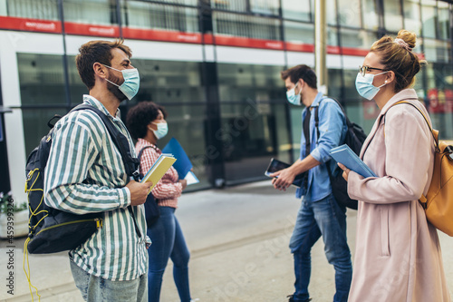 Distance learning. Social distance. New normal life. University students standing outdoor.