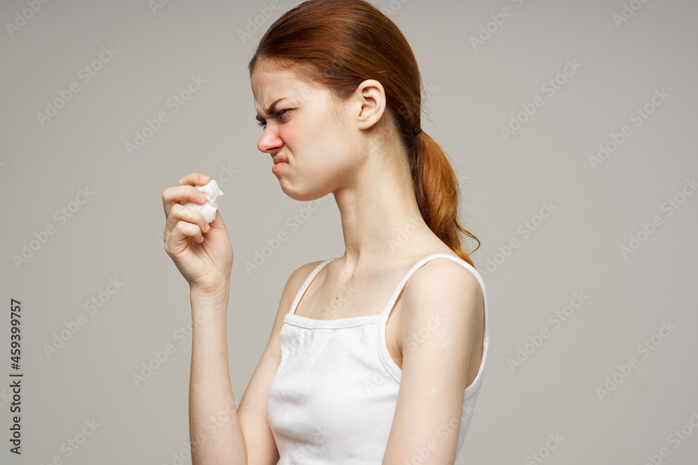 sick woman in white t-shirt with a scarf isolated background sick woman in white t-shirt with a scarf isolated background