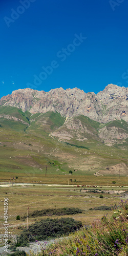 Mountains of North Ossetia, beautiful summer landscapes with blue sky and clouds. Vertical format.