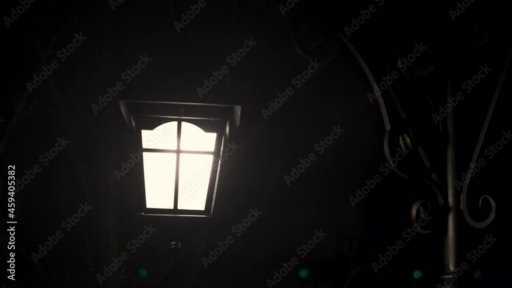 Snow covered street lamp. A bright street lamp in the snow in the night.