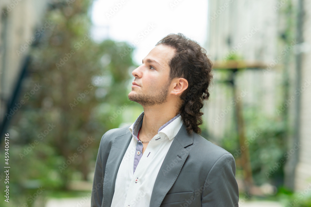 A young successful businessman is working outdoor using smartphone. Man in a casual wear. Business, freelance and remote work. A young successful businessman is working outdoor using smartphone. Man in a casual wear. Business, freelance and remote work.
