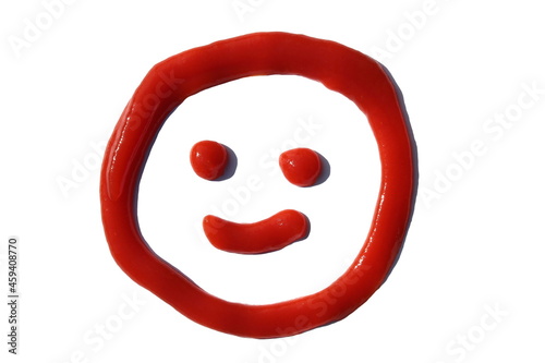 A face is drawn with tomato paste on a white isolated background.