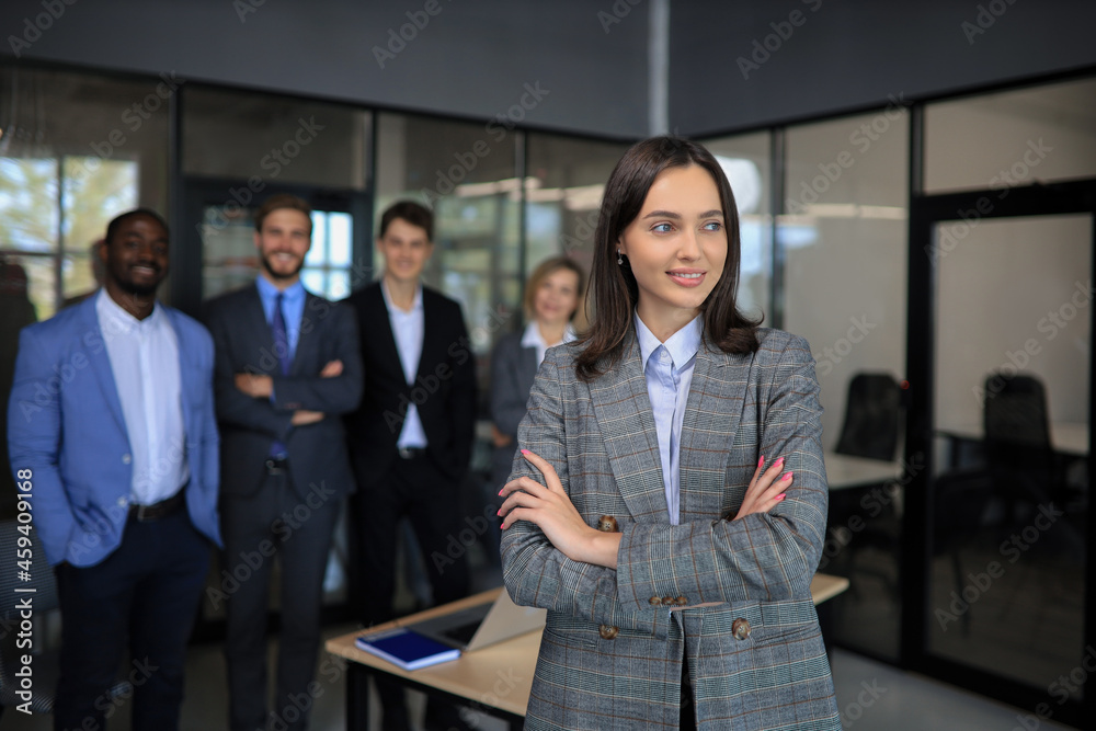 Business woman with her staff, people group in background at modern bright office indoors. Business woman with her staff, people group in background at modern bright office indoors.