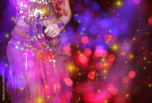 Belly Dancer wearing purple dance costume close up with bokeh © LMPark Photos