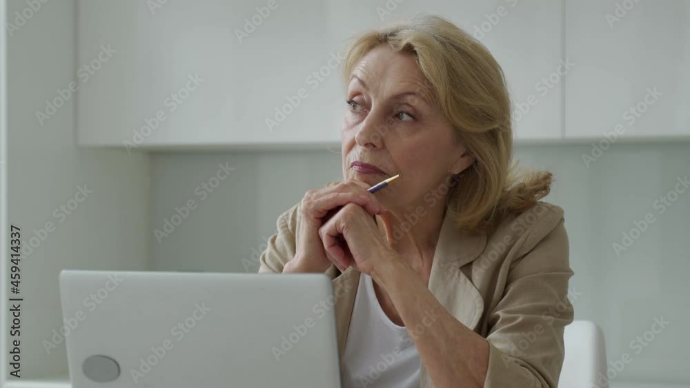 An inspired elderly businesswoman considering new creative ideas in the workplace. An inspired elderly businesswoman considering new creative ideas in the workplace.