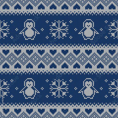 Knitted seamless pattern with penguins and snowflakes. Sweater background.