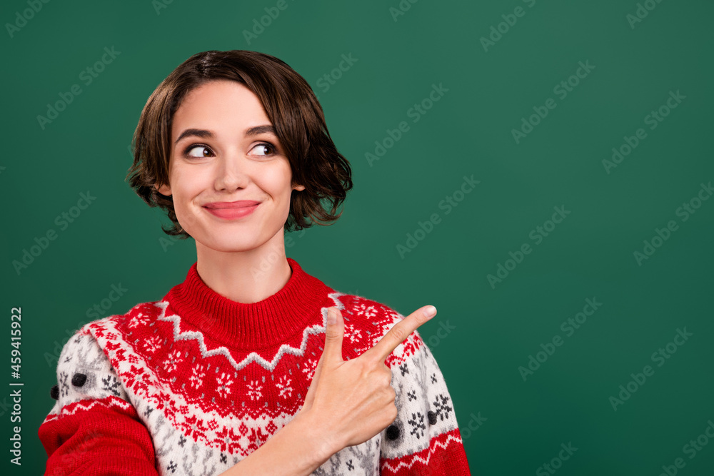 Portrait of attractive trendy cheerful curious girl demonstrating copy space idea advert isolated over green color background Portrait of attractive trendy cheerful curious girl demonstrating copy space idea advert isolated over green color background