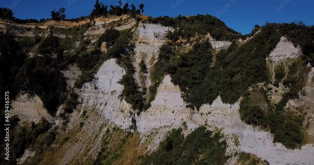 Summer aerial of dramatic clay cliffs and blue sky - Mangaweka, New Zealand Summer aerial of dramatic clay cliffs and blue sky - Mangaweka, New Zealand