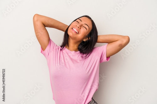 Young latin woman isolated on white background feeling confident, with hands behind the head.