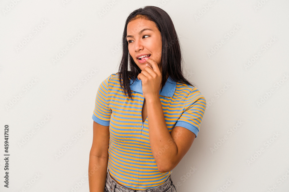 Young latin woman isolated on white background relaxed thinking about something looking at a copy space. Young latin woman isolated on white background relaxed thinking about something looking at a copy space.