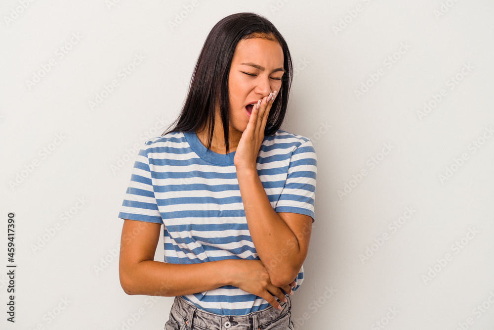 Young latin woman isolated on white background yawning showing a tired gesture covering mouth with hand. Young latin woman isolated on white background yawning showing a tired gesture covering mouth with hand.