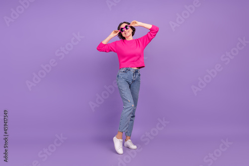 Full body photo of senior woman happy positive smile hand touch glasses isolated over purple color background
