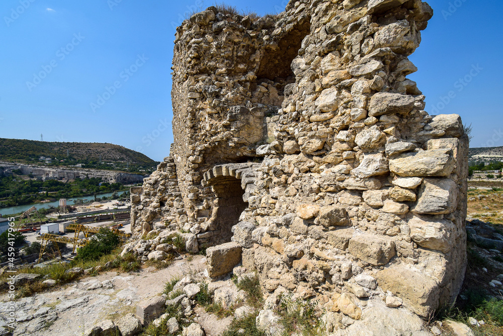 A fragment of an old stone fortress standing on a mountain