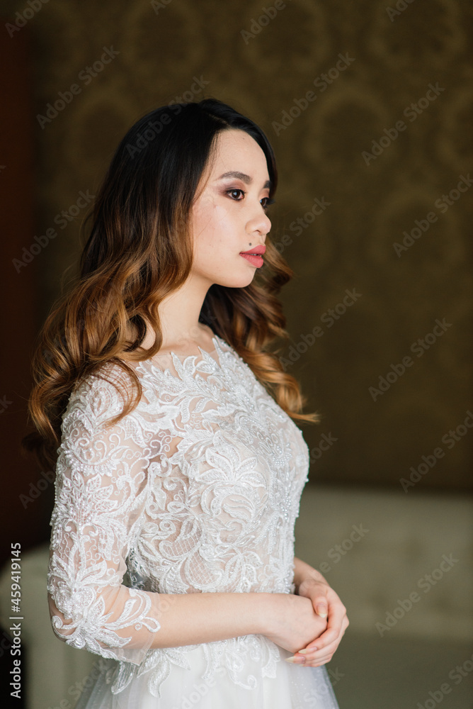 Fototapeta premium Young stylish asian woman in white dress, vintage style, natural, innocent, smiling in hotel