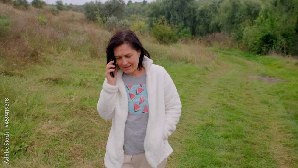 Portrait of beautiful smiling woman talking on mobile phone outdoors Portrait of beautiful smiling woman talking on mobile phone outdoors
