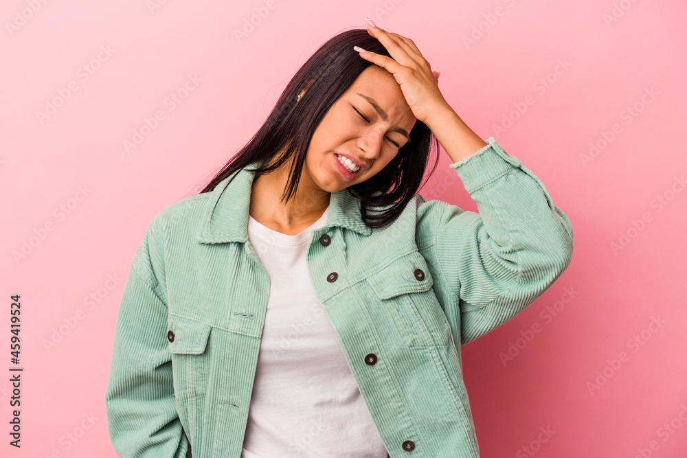 Young latin woman isolated on pink background  forgetting something, slapping forehead with palm and closing eyes.