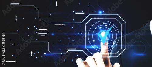Close up of businessman hand pointing at abstract glowing digital business circuit network and tick mark interface on blurry background. Technology, choice and completion concept. Double exposure.