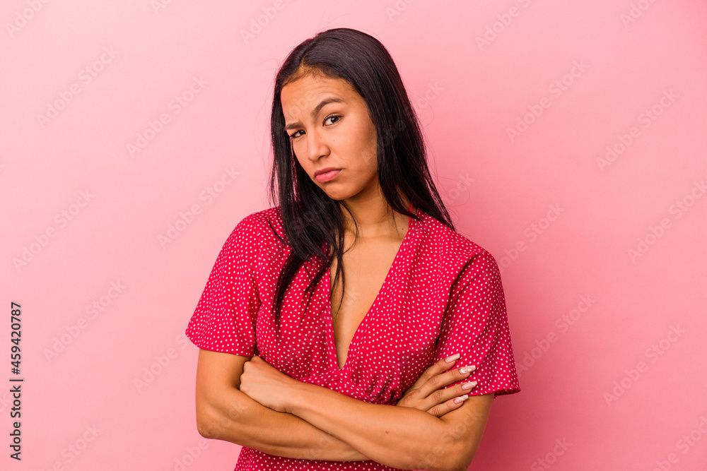 Young latin woman isolated on pink background tired of a repetitive task. Young latin woman isolated on pink background tired of a repetitive task.