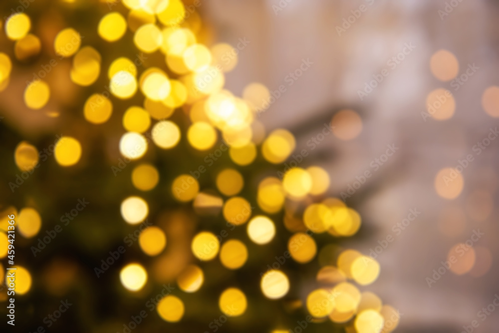 Blurred colorful festive background. Out of focus Christmas tree with garland. Texture for postcards
