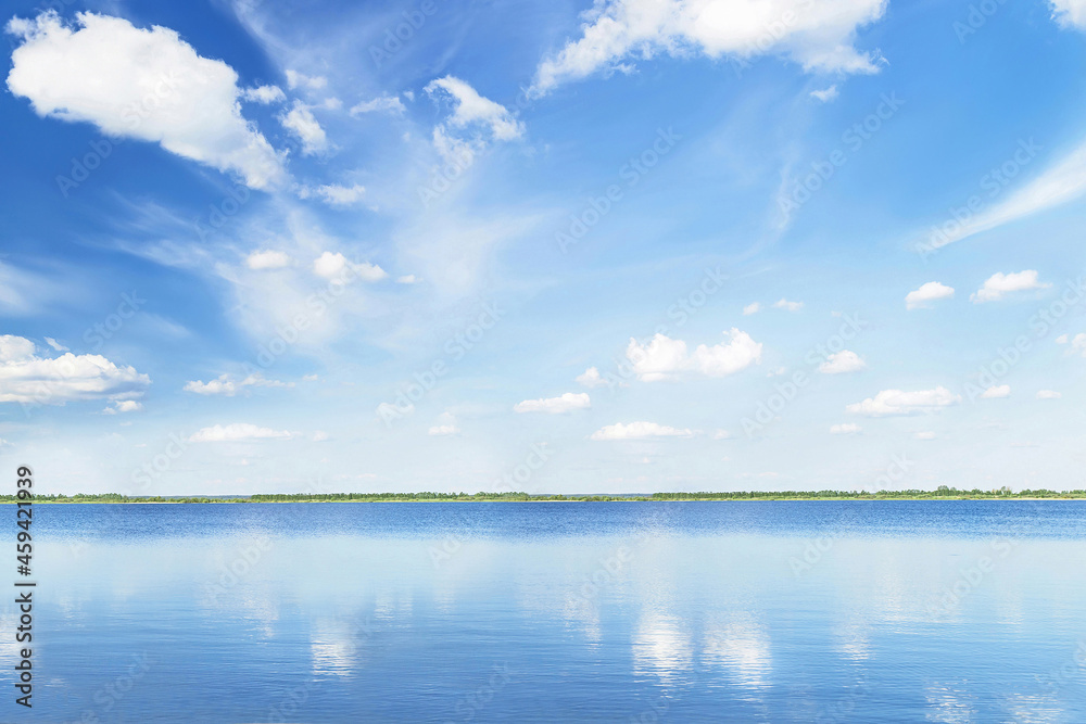 Blue sky with light clouds soft focus, trees and reflection in water in sunny summer day. Picturesque view. Empty place for message. Copy space. Vacations (travel), relax, happiness, ecology  concept.
