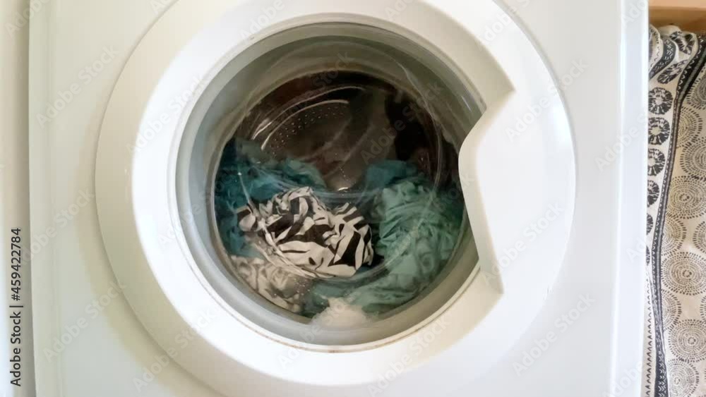 Washing machine door with rotating garments inside Washing machine door with rotating garments inside