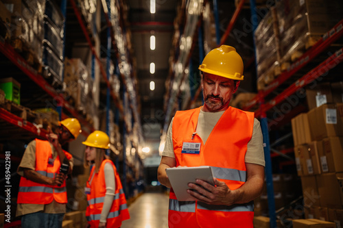 Male warehouse worker with a tablet.