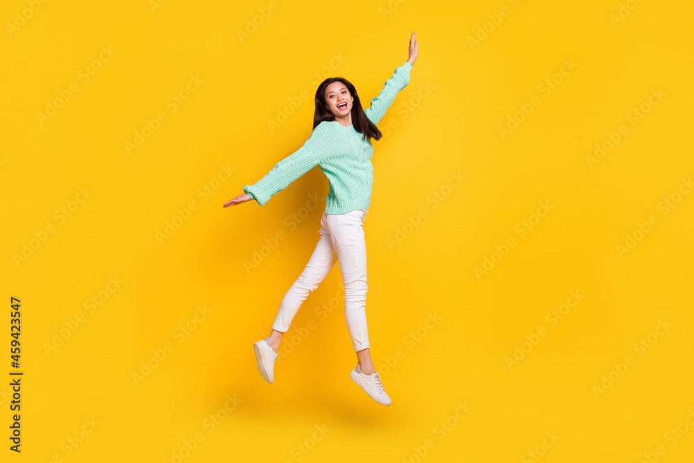Full length photo of cheerful young positive young woman jump up active lady isolated on yellow color background