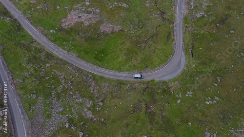 Downward angle drone shot of vehicles on Bealach Na Ba Applecross road through the mountains of the Applecross peninsula, in Wester Ross in the Scottish Highlands photo