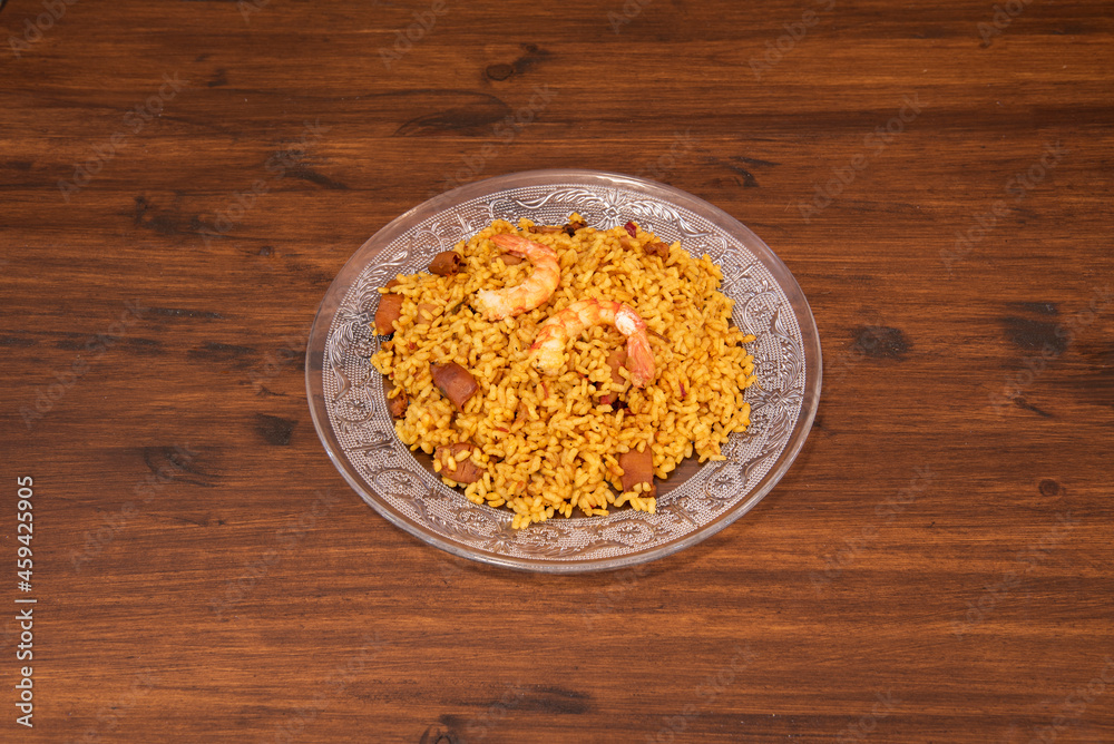 Senyoret rice paella with seafood, prawns and squid on a glass plate Senyoret rice paella with seafood, prawns and squid on a glass plate