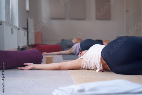 Wallpaper Mural Women stretching and relaxing on the floor in a yoga class Torontodigital.ca