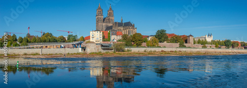 Panoramic view over Magdeburg historical downtown, Elbe river and the cathedral in early Autumn at blue sky and sunny day, Magdeburg, Germany.