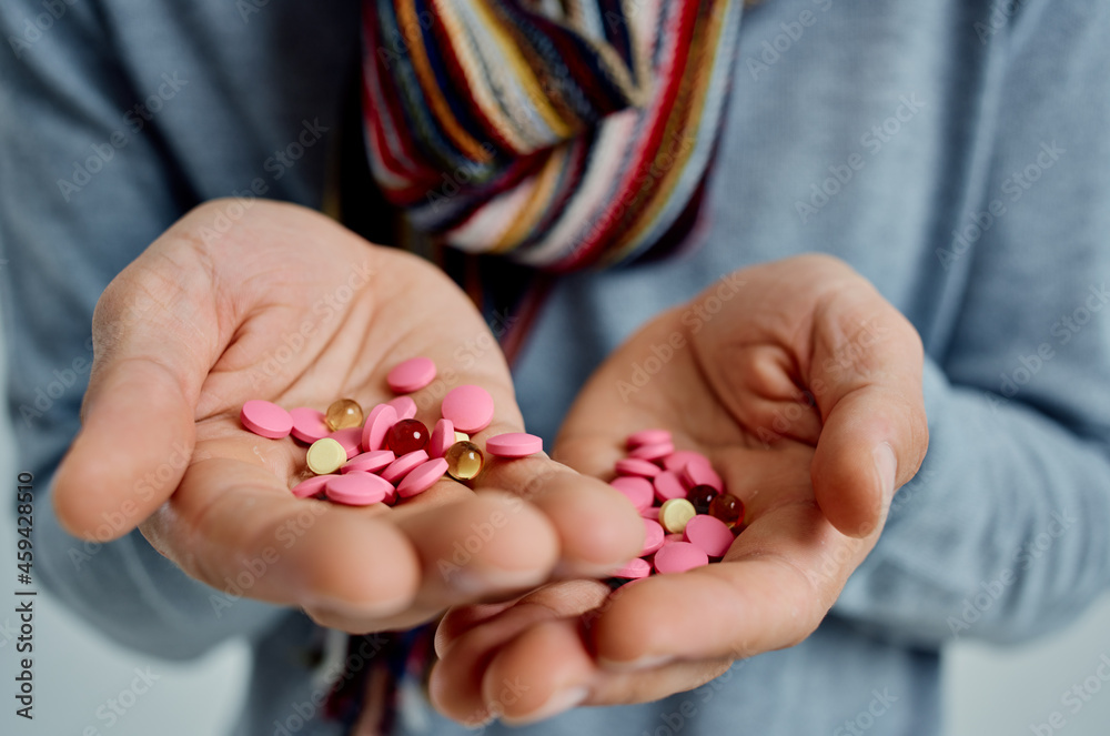 sick man treating the disease with pills in hands isolated background sick man treating the disease with pills in hands isolated background