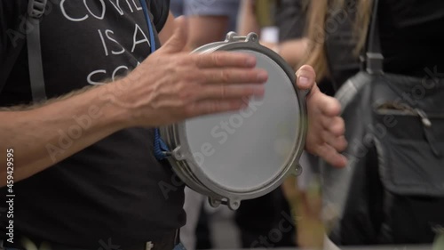 London Anti Vaccine Lockdown Protests Close Up Of Protester Playing Drum Slow Motion photo