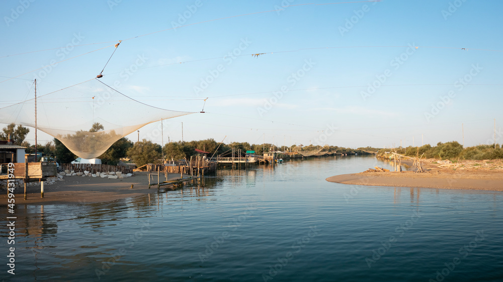 Fototapeta premium Landscape of fishing huts in the river with typical italian fishing machine, called 