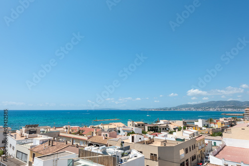 Sea views from the roof of a house with close-up views of the neighboring roofs. Blue sky . Mediterranean sea bay