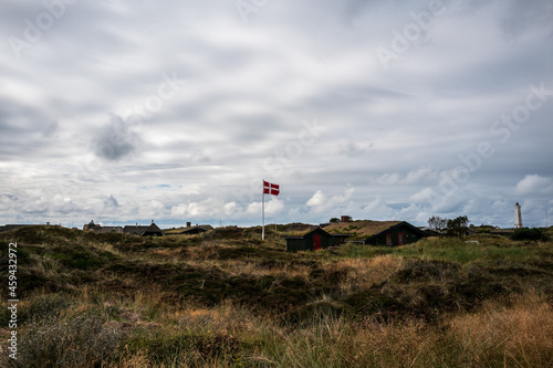 lighthouse on the hill and danish flag