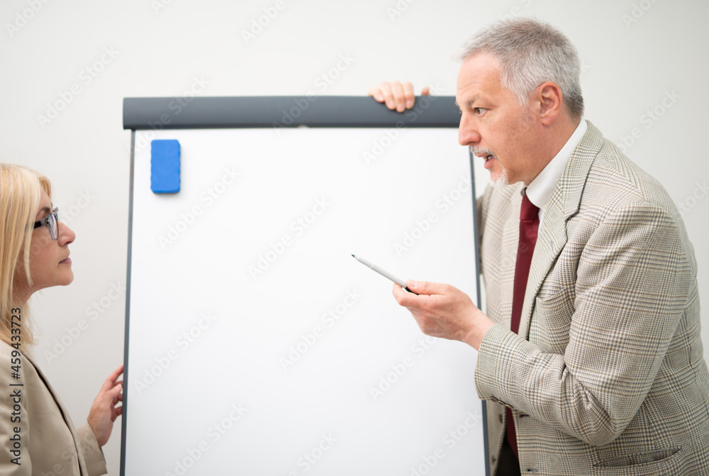 Businessman showing data on an empty whiteboard Businessman showing data on an empty whiteboard