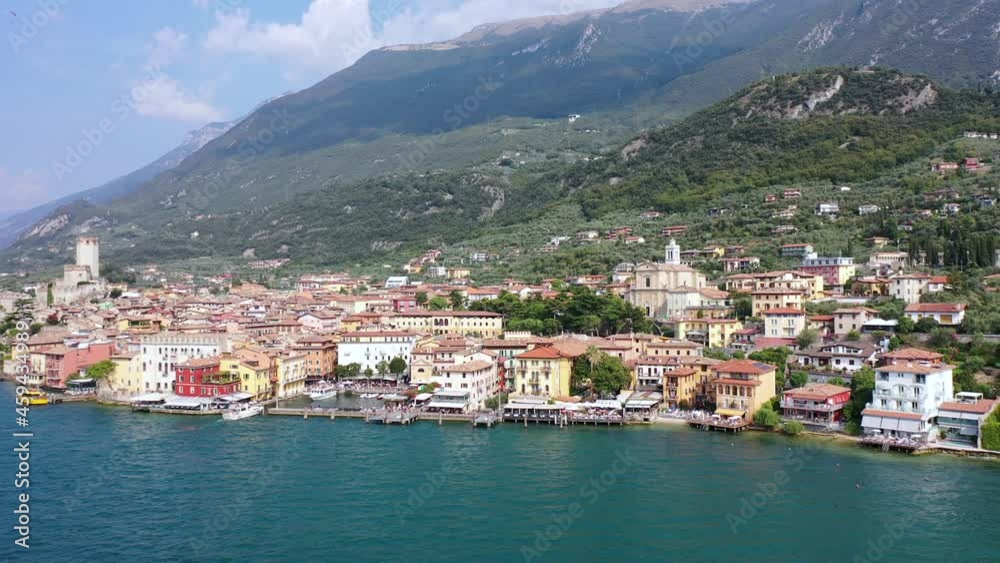 Aerial video view from waterfront of the historic city of Malcesine, the Scaliger Castle in Malcesine, the port and restaurants of old town, Lake Garda, Italy - K4 movie Aerial video view from waterfront of the historic city of Malcesine, the Scaliger Castle in Malcesine, the port and restaurants of old town, Lake Garda, Italy - K4 movie
