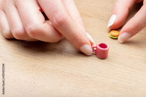 hands with mini food on a table