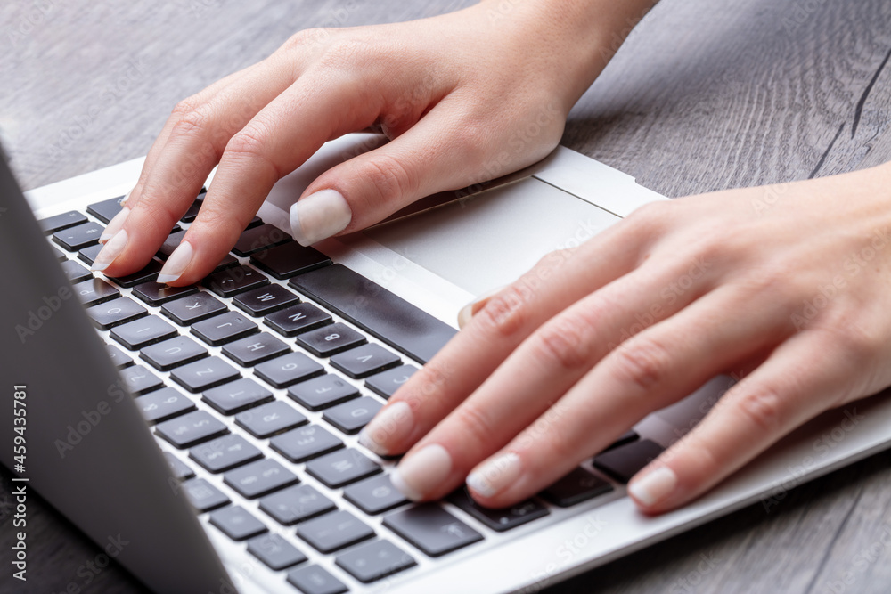 detail of perfectly manicured hands on laptop keyboard detail of perfectly manicured hands on laptop keyboard