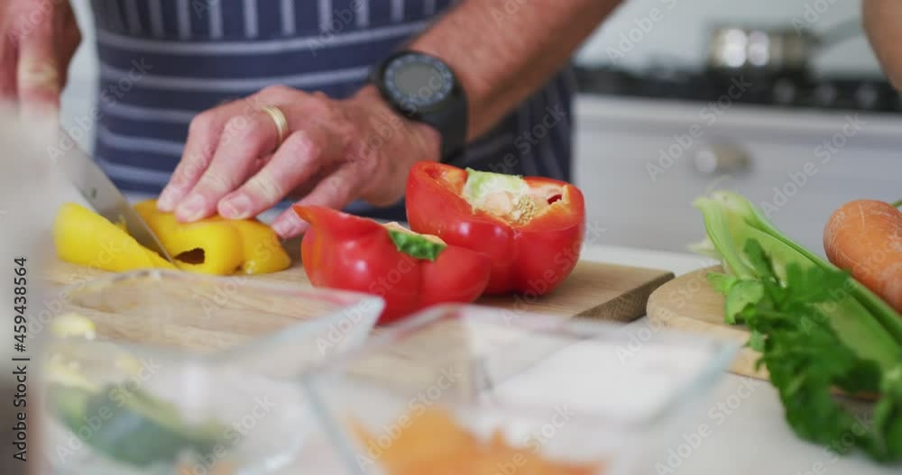 Animation of hands of caucasian senior man chopping vegetables in kitchen Animation of hands of caucasian senior man chopping vegetables in kitchen