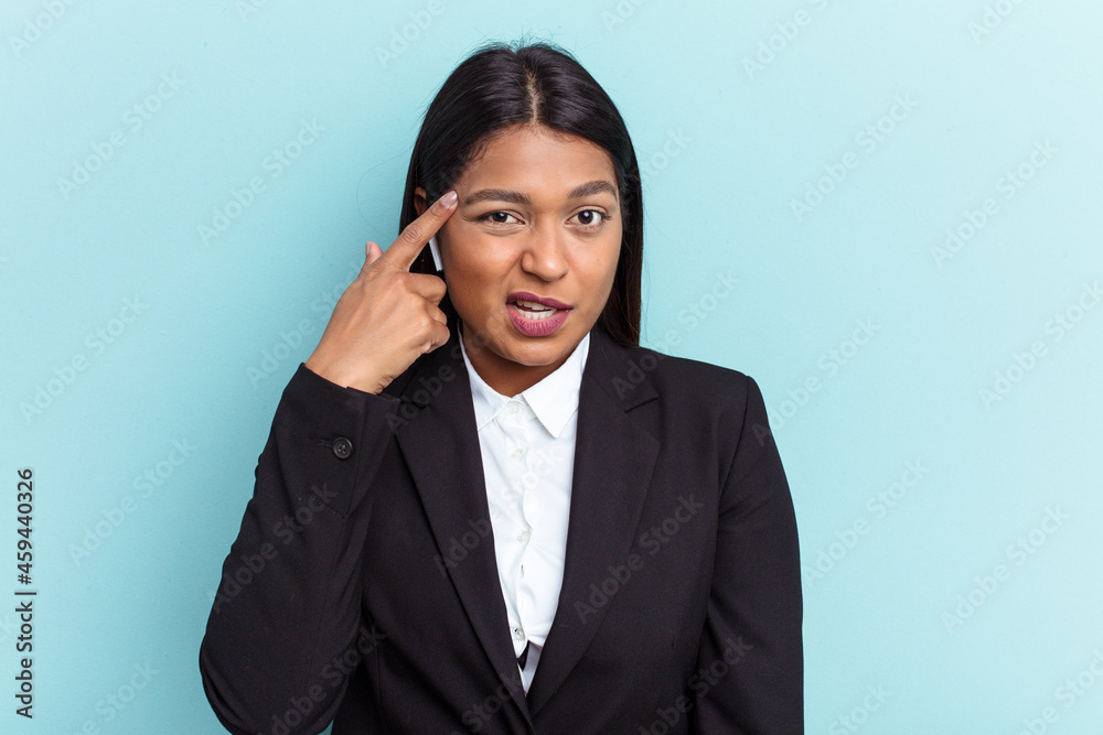 Young Venezuelan business woman isolated on blue background showing a disappointment gesture with forefinger. Young Venezuelan business woman isolated on blue background showing a disappointment gesture with forefinger.