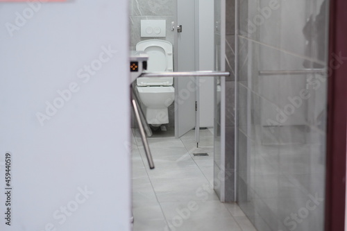 a city toilet room and a control turnstile for entry and exit. selective focus