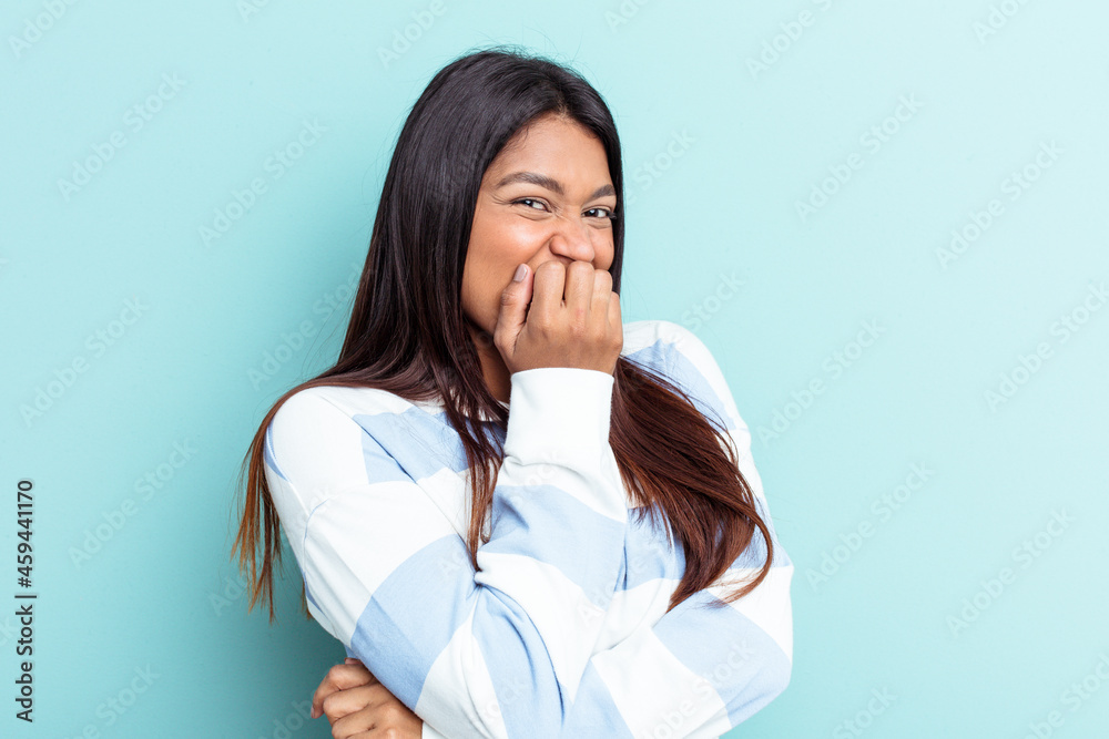 Young Venezuelan woman isolated on blue background biting fingernails, nervous and very anxious. Young Venezuelan woman isolated on blue background biting fingernails, nervous and very anxious.