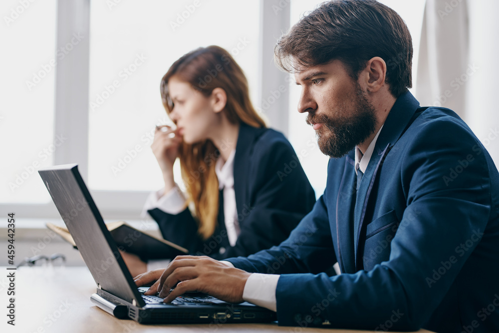 managers sitting in front of a laptop teamwork internet officials managers sitting in front of a laptop teamwork internet officials